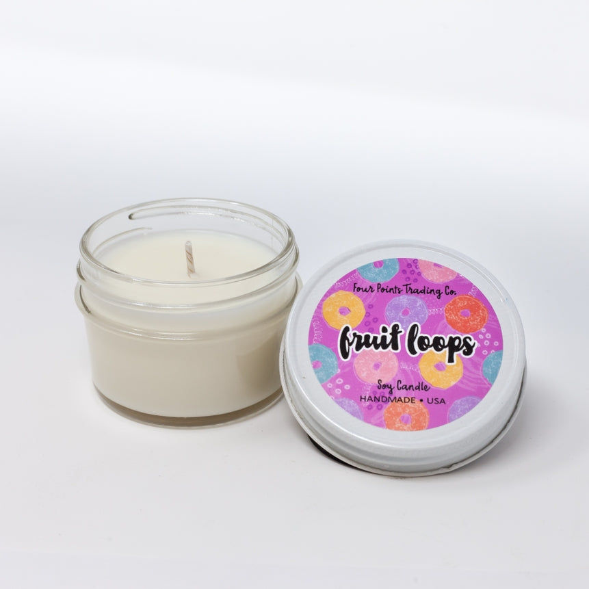 Pop Scents soy candle in a clear glass jar with white wax.
