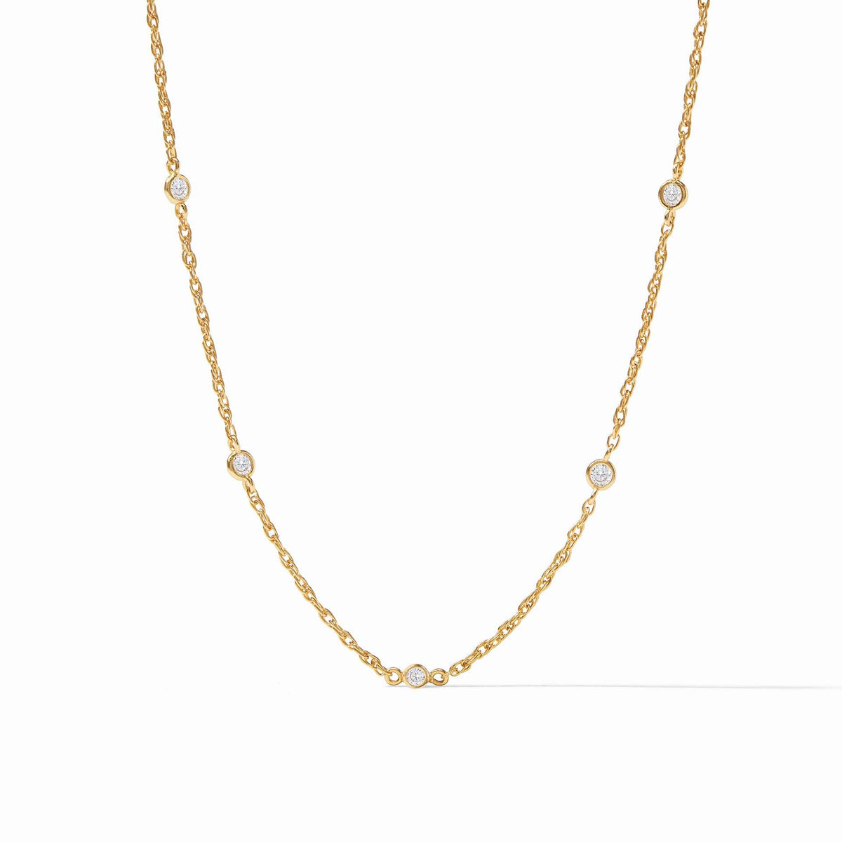 Celeste gold station necklace with five bezel-set cubic zirconia stones on a delicate chain.