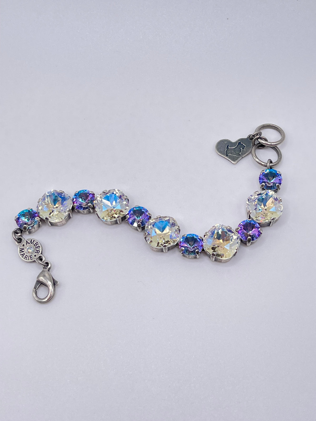 Amber Marie bracelet featuring alternating iridescent crystal stones and a small dog charm.