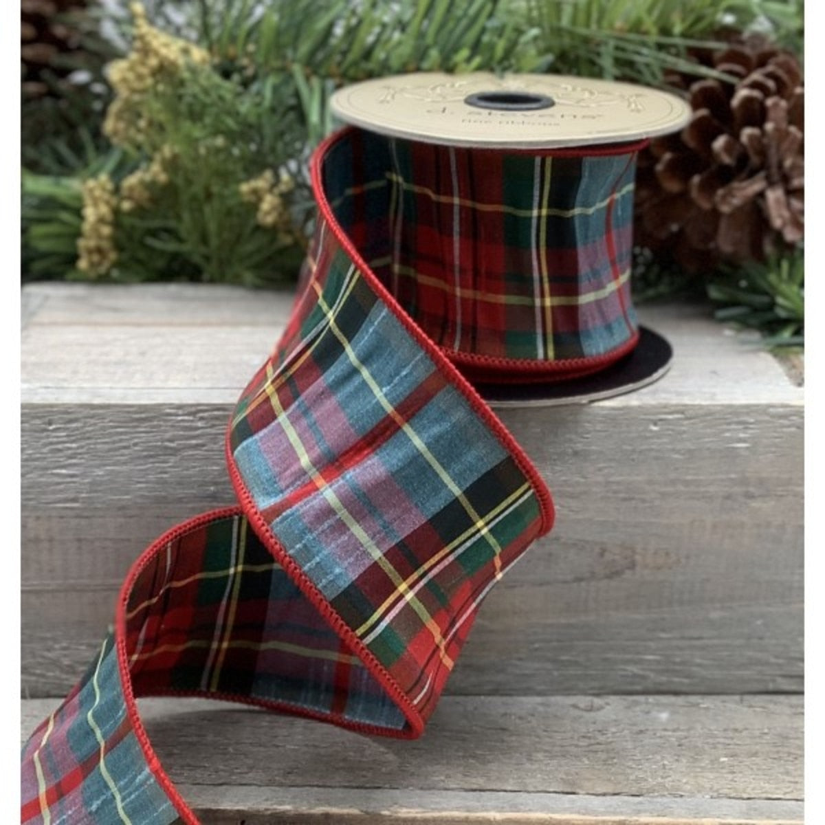4 inch wide blue and red tradition tartan plaid faux dupion ribbon on a spool.
