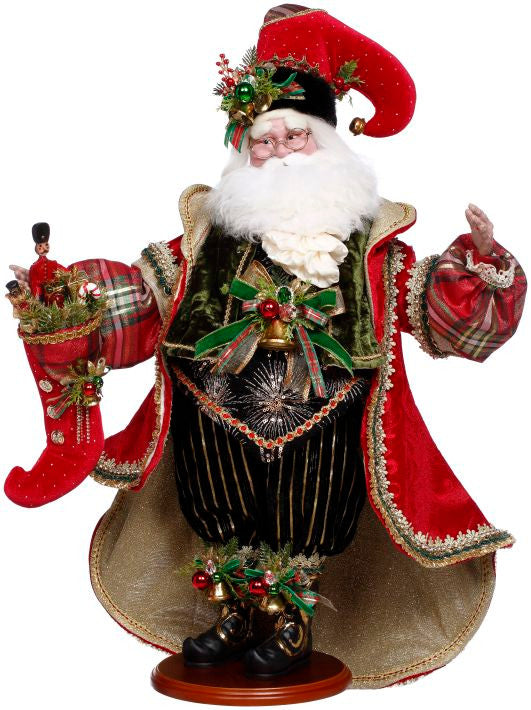 Ornate Santa Claus figurine wearing a red velvet coat and holding a red stocking filled with toys.
