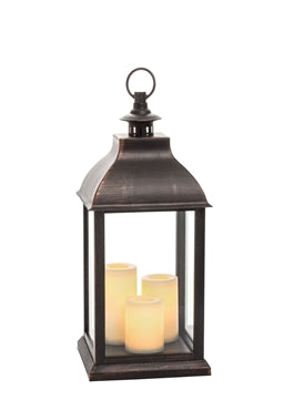 Three pillar jumbo candle lantern in natural wood finish with open geometric cutouts.