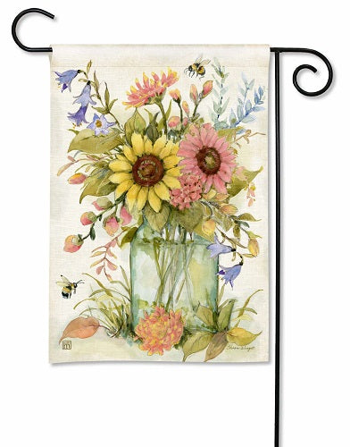 Garden flag with a watercolor painting of sunflowers, pink daisies, bluebells, and bees in a glass vase.