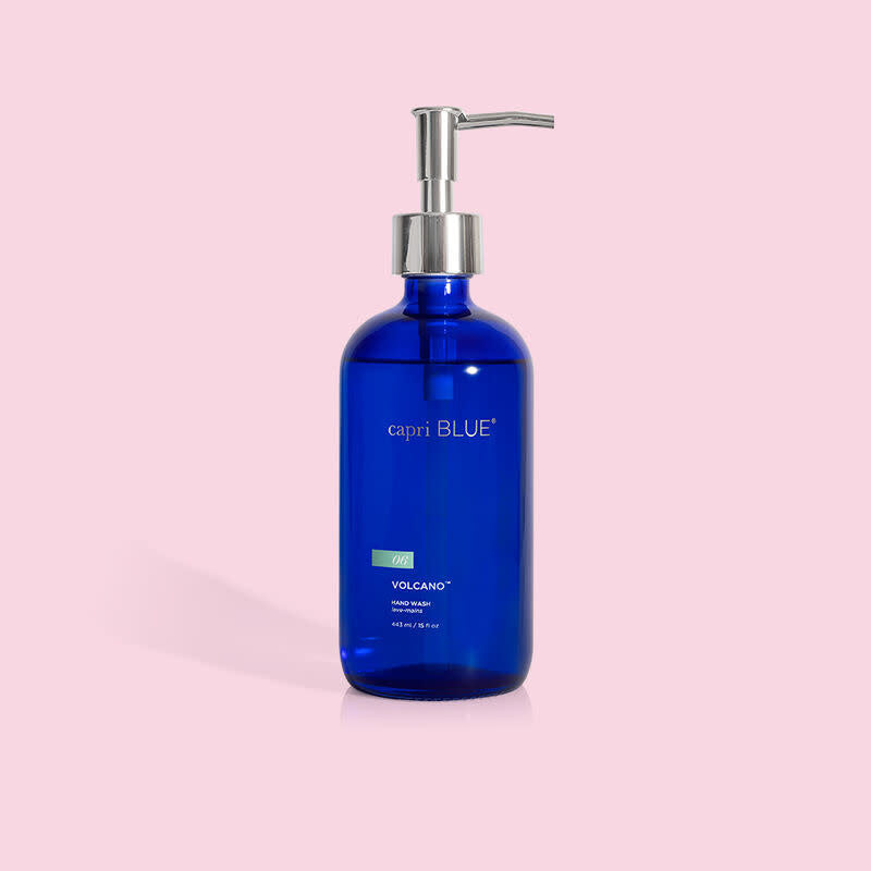 Cobalt blue glass bottle with white pump dispenser containing Volcano large hand wash.