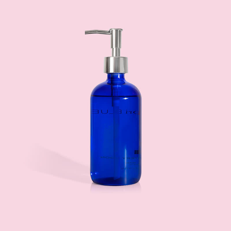Cobalt blue glass bottle with white pump containing Volcano large hand wash.