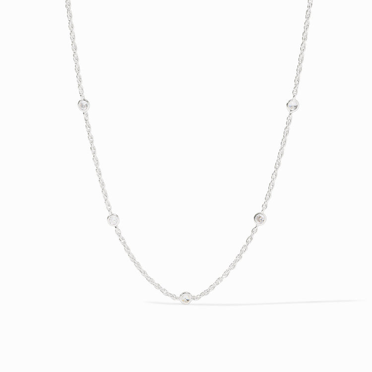 Silver station necklace with five bezel-set cubic zirconia stones on a delicate chain.