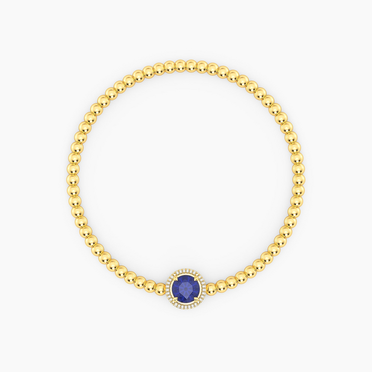 Gold-plated beaded bracelet with a round-cut blue tanzanite center stone and diamond halo.