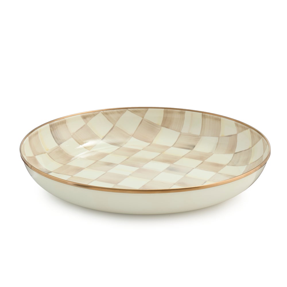 Hand-glazed steel abundant bowl with mocha checkered pattern on rimmed bronzed stainless steel edge.