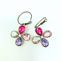 Silver-tone pierced hoop earrings featuring a multi-rhinestone cross pendant.