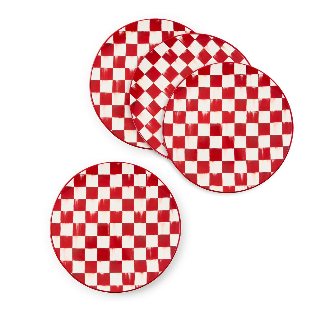 Set of four stoneware dinner plates with a red and white hand-painted checkered pattern.
