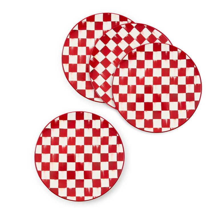 Set of four stoneware dinner plates with a red and white hand-painted checkered pattern.