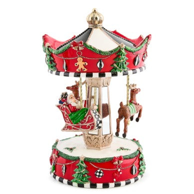 Decorative Christmas carousel with Santa in a sleigh and reindeer on a red and white base.