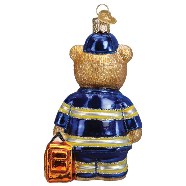 Back view of a glass EMT Teddy Bear ornament in a blue uniform with reflective stripes and a bag.