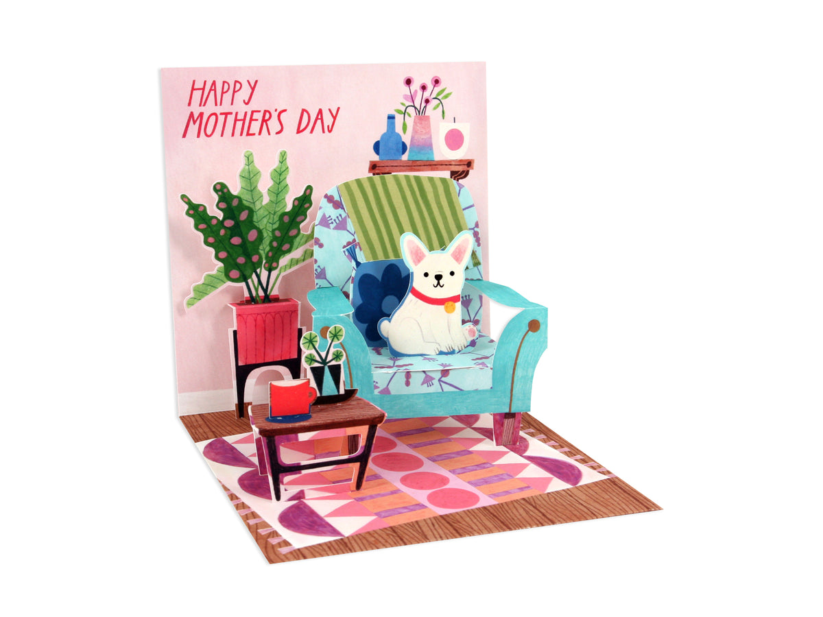 Pop-up Mother's Day card featuring a white dog on a blue armchair in a cozy living room setting.