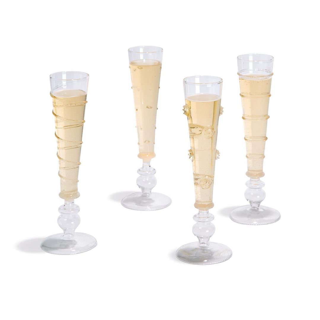 Four unique hand-blown glass champagne flutes with various geometric and textured patterns.
