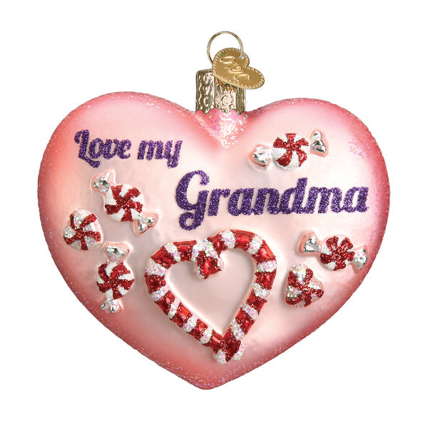 Pink heart-shaped glass ornament with 'Love my Grandma' text and candy cane decorations.