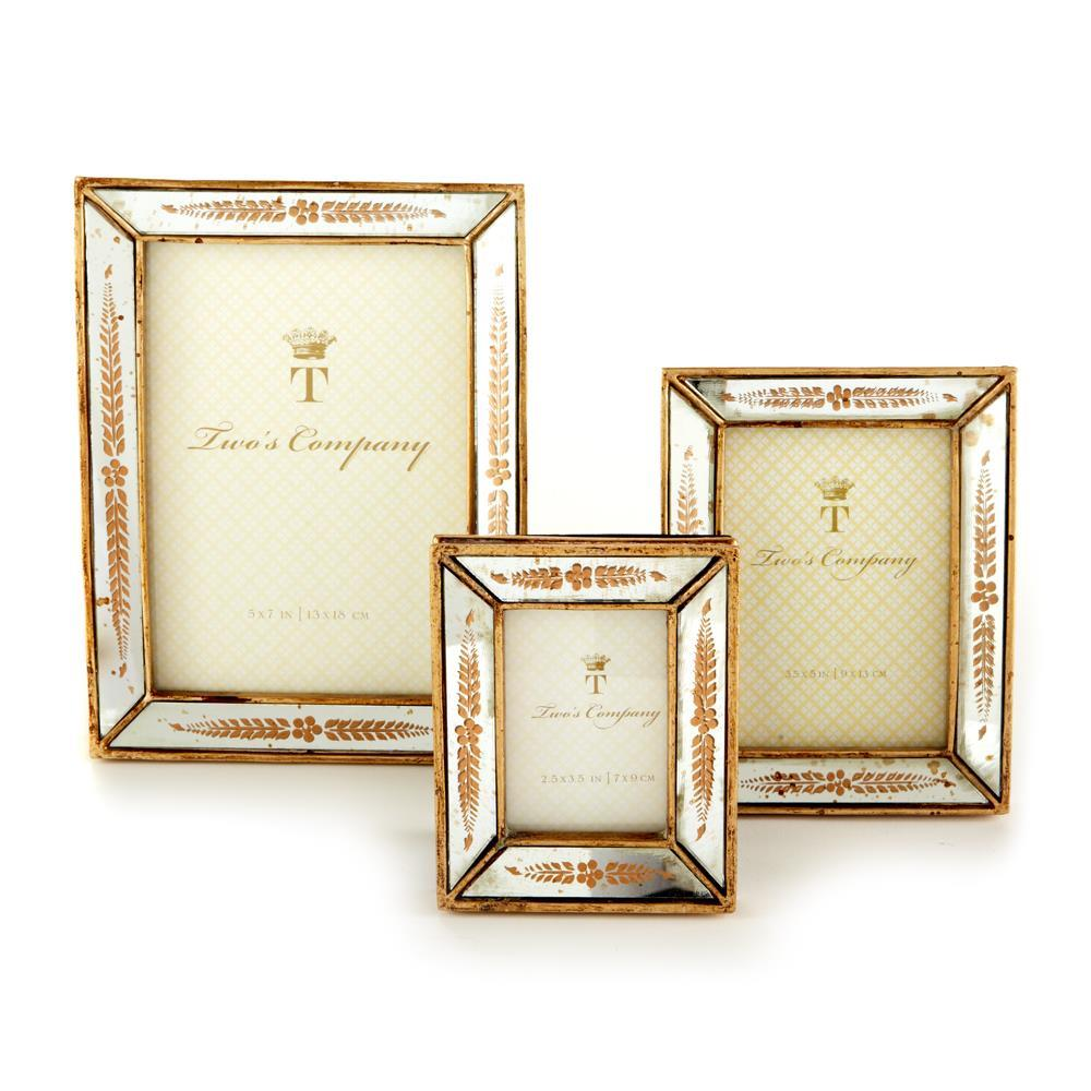 Three gold leaf mirror photo frames in small, medium, and large sizes with floral etched borders.