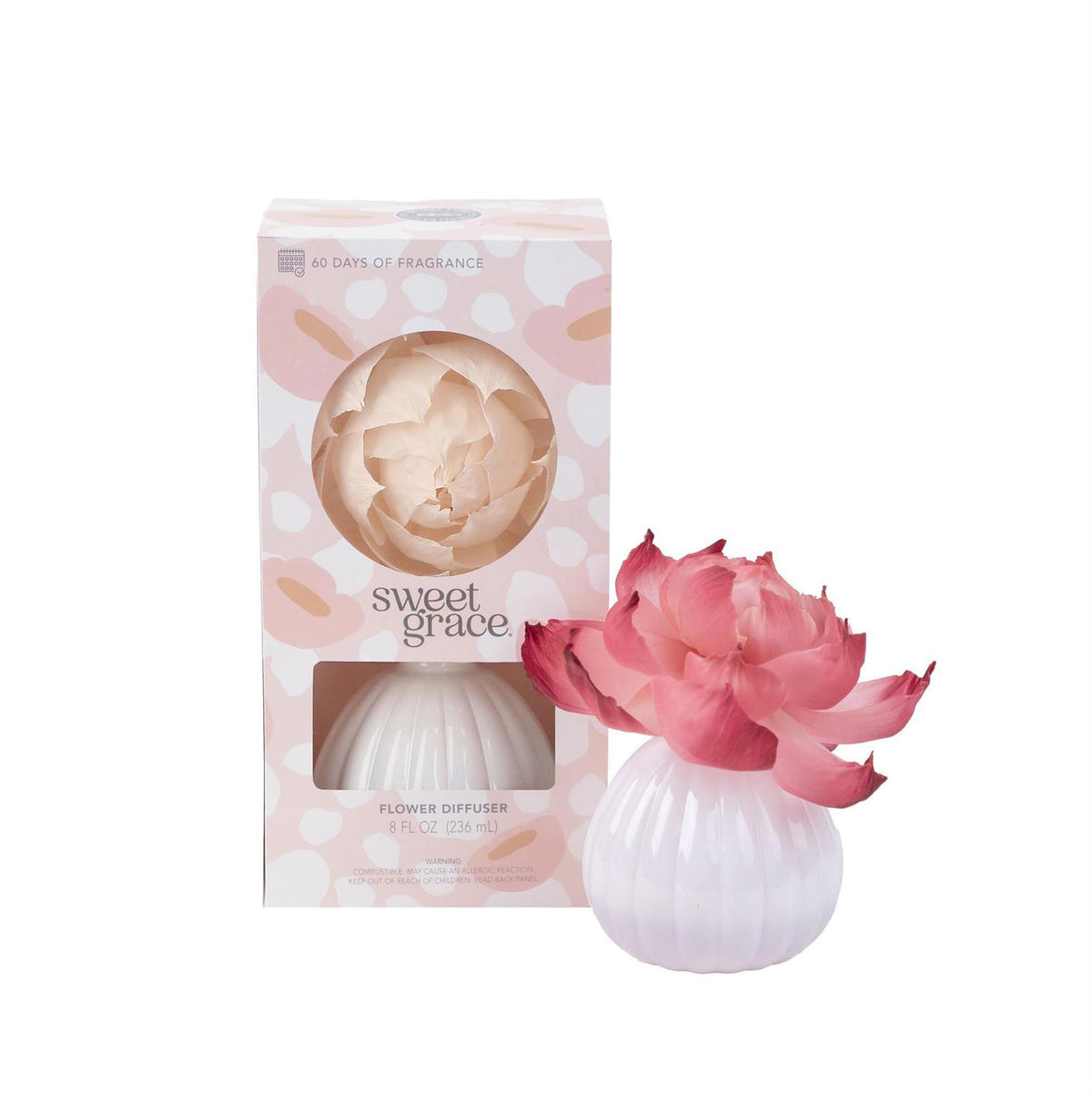 Sweet Grace flower diffuser bottle with pink blooming silk flower stem extending from cork stopper.