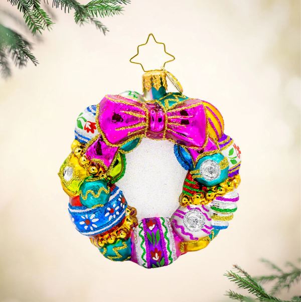 Vintage Holiday Wreath Gem glass ornament with colorful baubles and a bright pink bow.