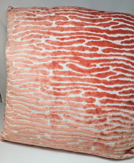 A 24x24 inch pillow with a coral and white abstract wavy stripe pattern.