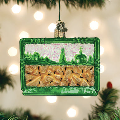 Glass ant habitat Christmas ornament with green frame, glittery sand, and tiny black ants.