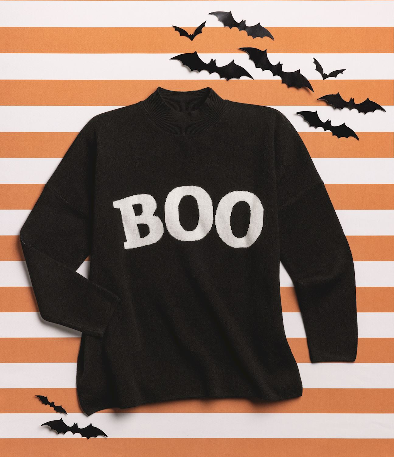 Black jacquard knit sweater with white 'BOO' text on a striped background with bat decorations.