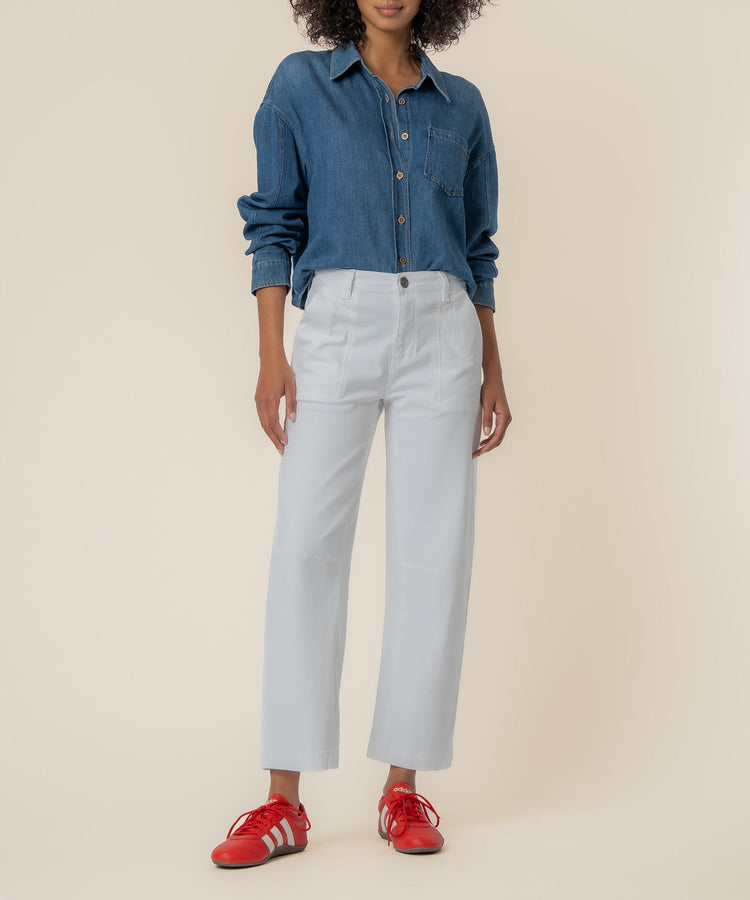 Woman wearing Sandy Ashton high-rise wide-leg barrel pants in light blue with a denim shirt.