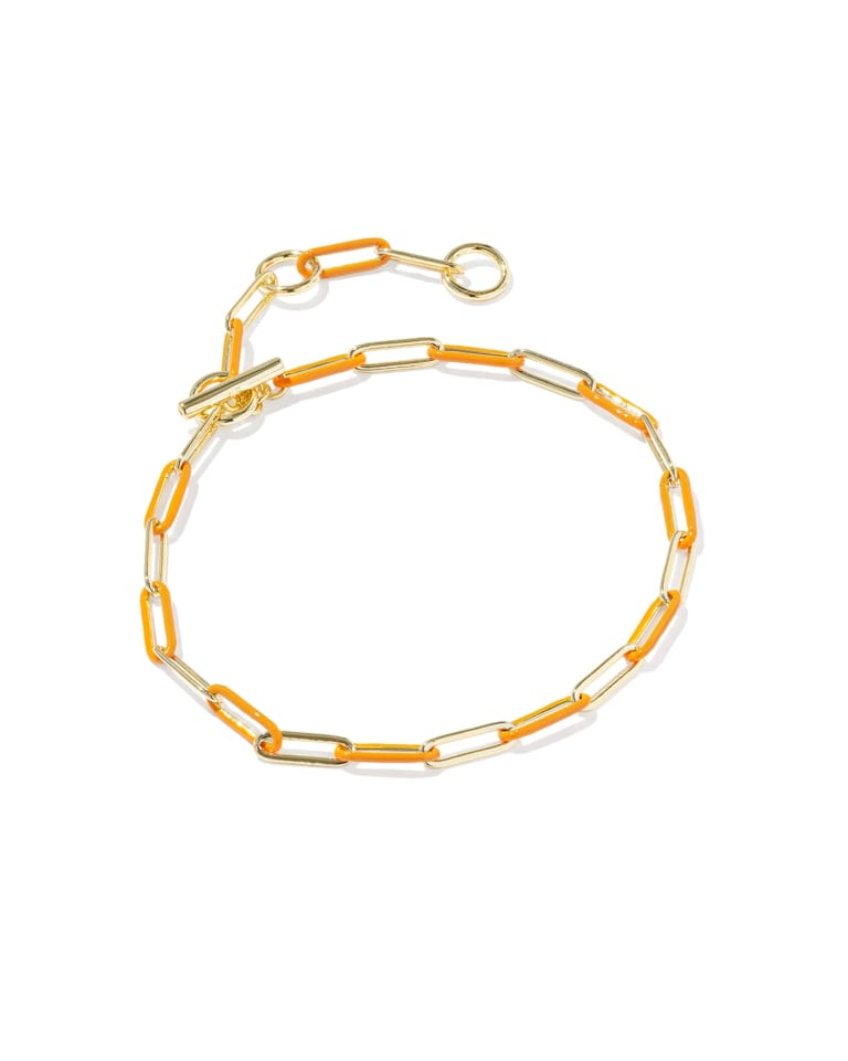 Courtney gold chain bracelet with orange enamel links and a toggle closure.