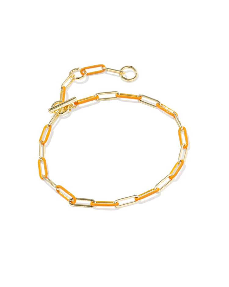 Courtney gold chain bracelet with orange enamel links and a toggle closure.