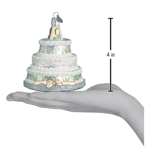 Wedding Cake Christmas Ornament, 4-inch tiered white glass cake with glitter and gold accents.