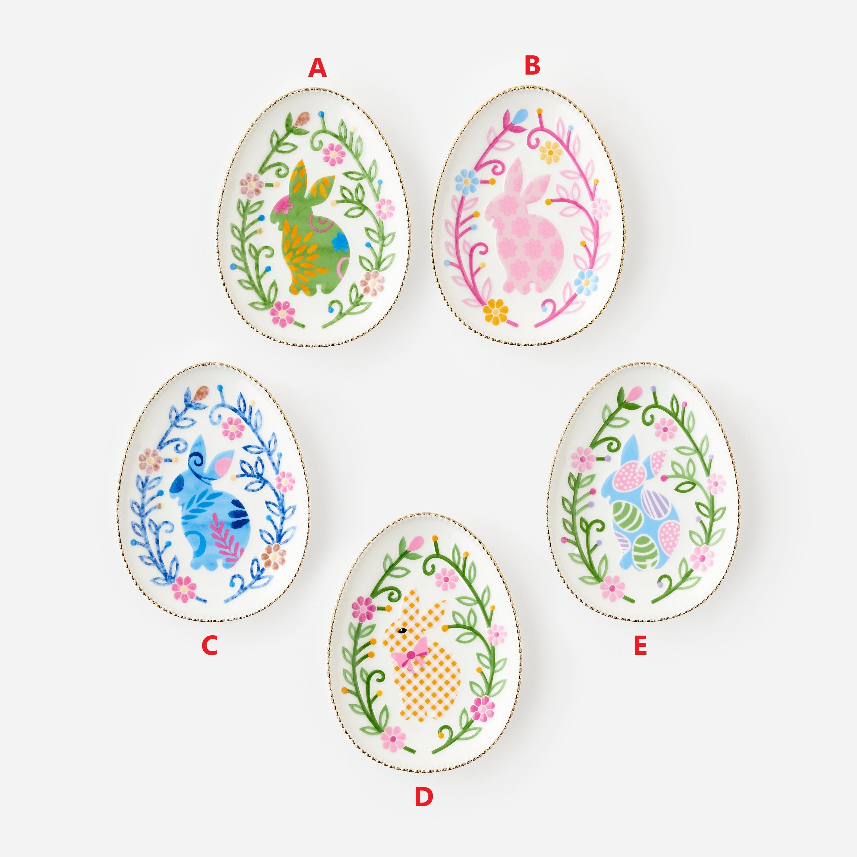 Five 6-inch egg-shaped ceramic dishes with colorful bunny and floral designs, labeled A through E.
