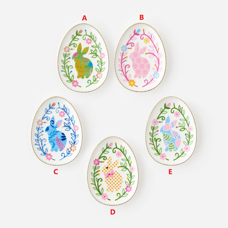 Five 6-inch egg-shaped ceramic dishes with colorful bunny and floral designs, labeled A through E.