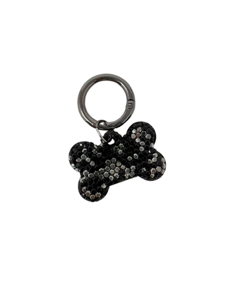 Bone-shaped dog tag with black and silver rhinestones on a gunmetal grey keyring.