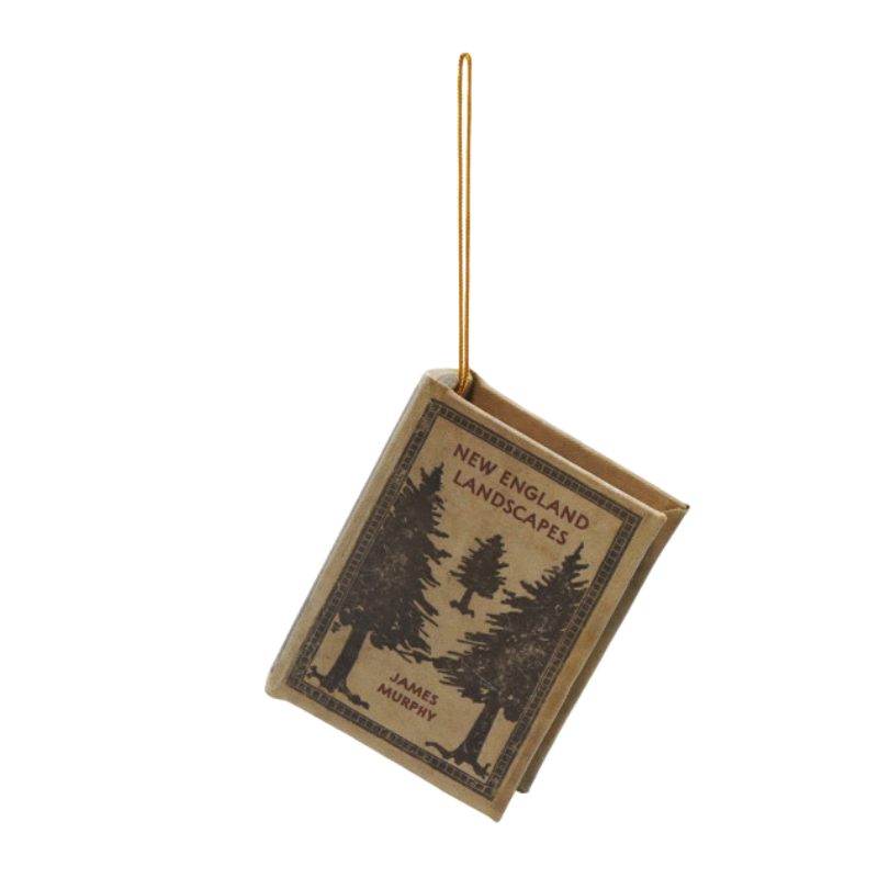 MDF and fabric book ornament titled New England Landscapes by James Murphy with a gold hanging loop.