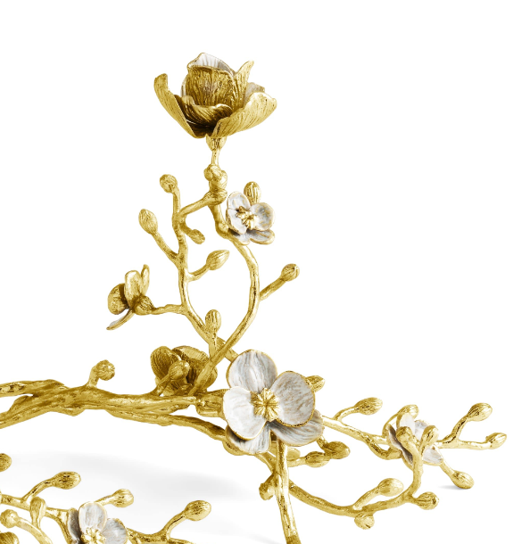 Natural brass sculptural candleholder with white enamel finish holding a small candle