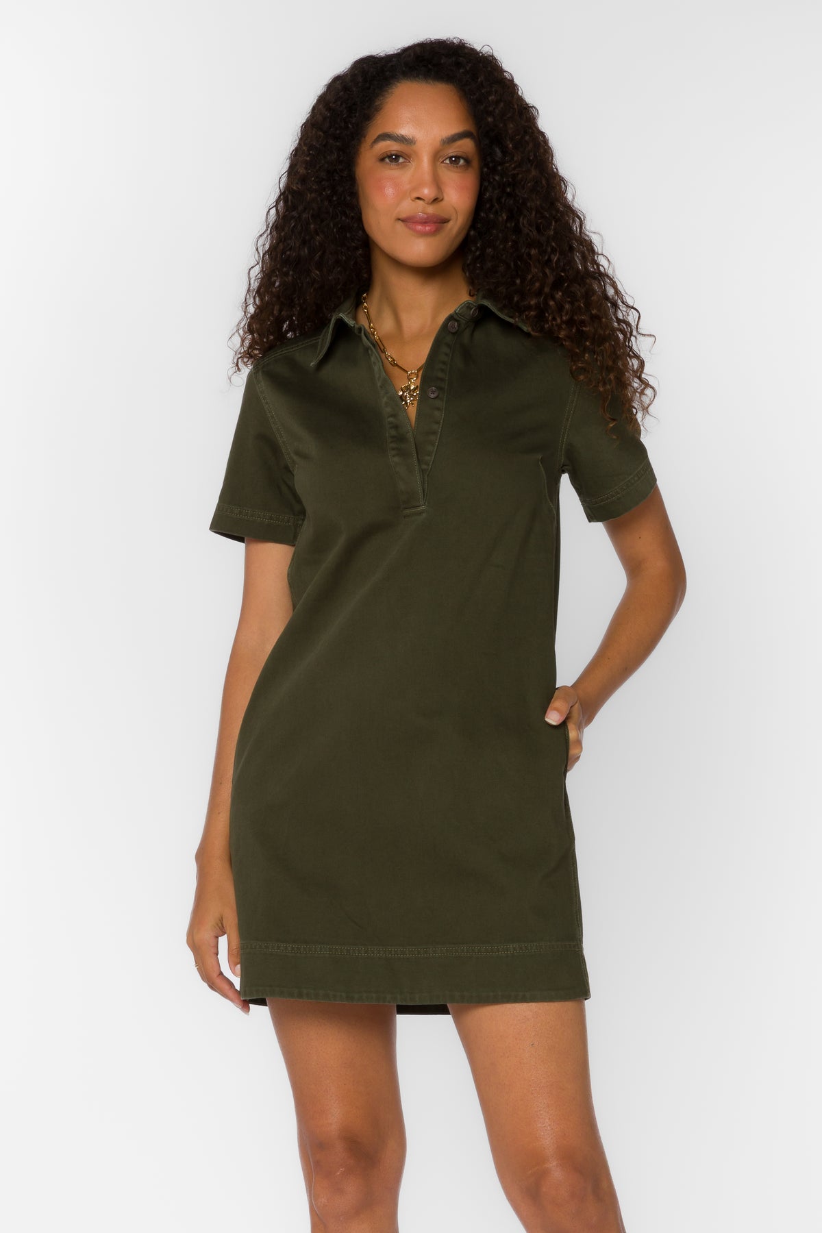 Woman wearing the Macayle Mini Dress in olive green with a split V-neckline and short sleeves.
