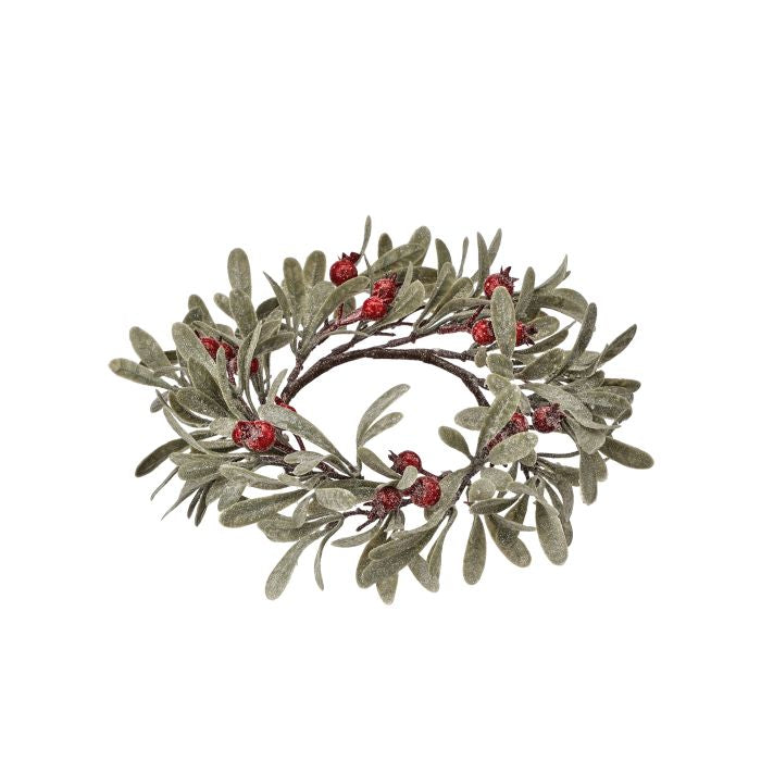 Frosted mistletoe candle ring with green leaves and red berries.