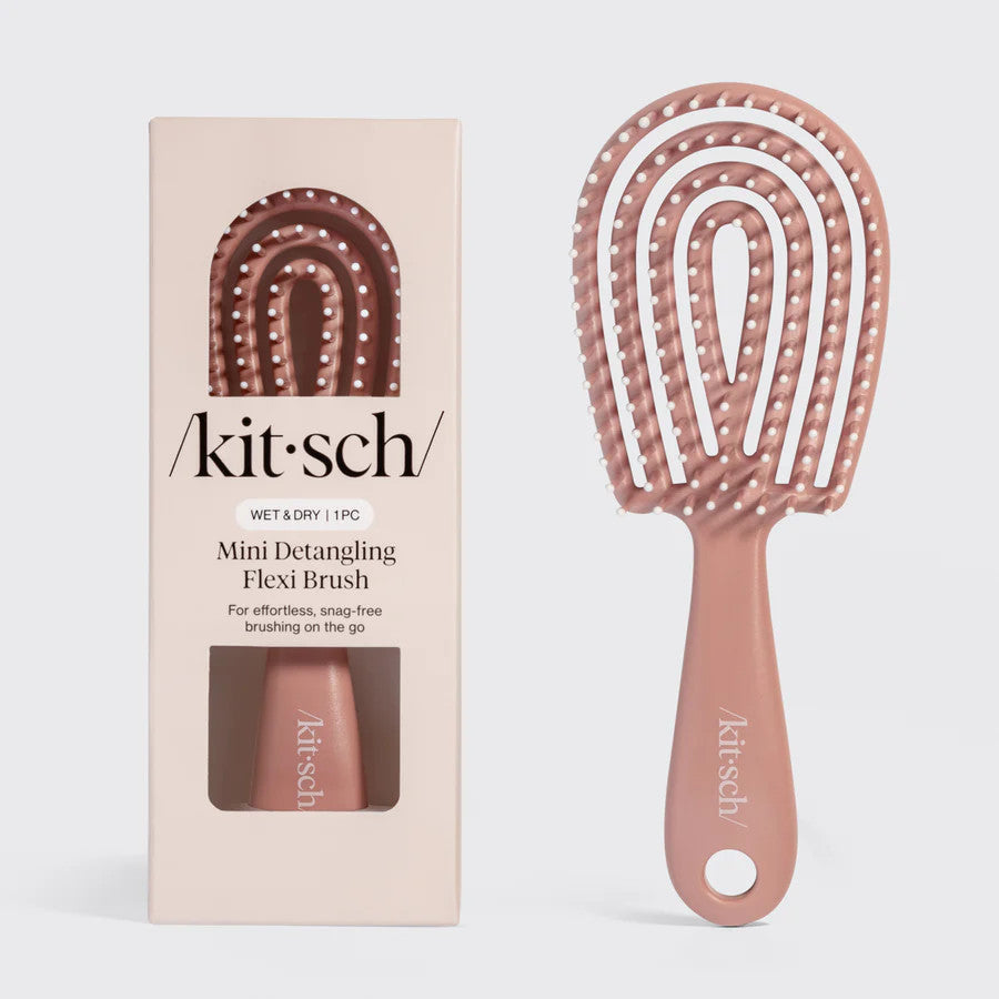 Mini terracotta-colored flexible detangling brush with bendable bristles in recycled plastic.