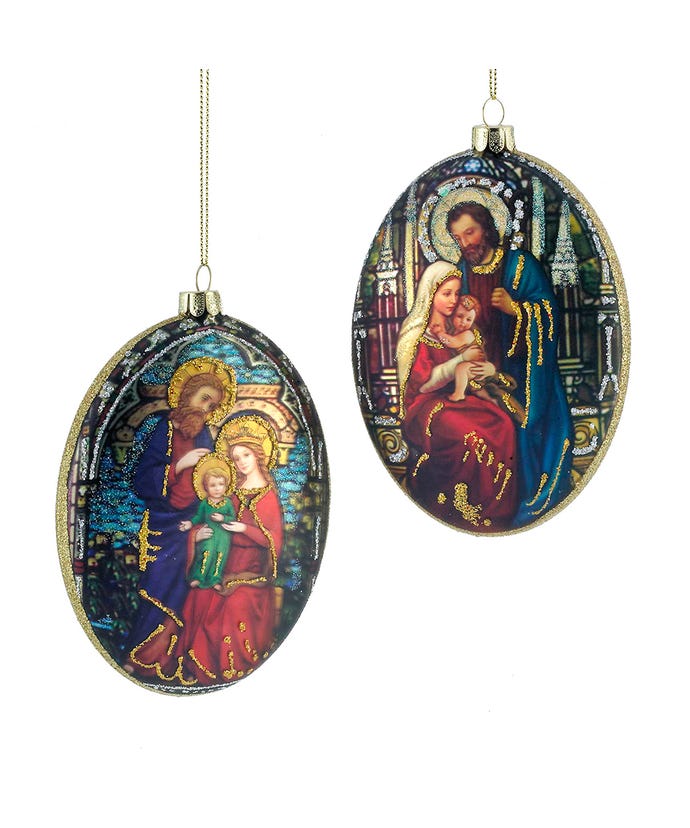 Oval glass ornament featuring an intricate illustration of baby Jesus with Mary and Joseph.