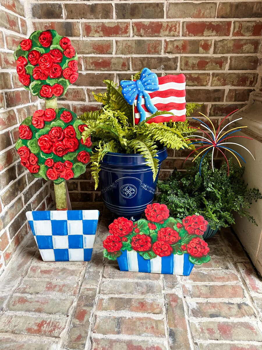 Checked Pot Geranium topiary in a square pot with vertical stripes.