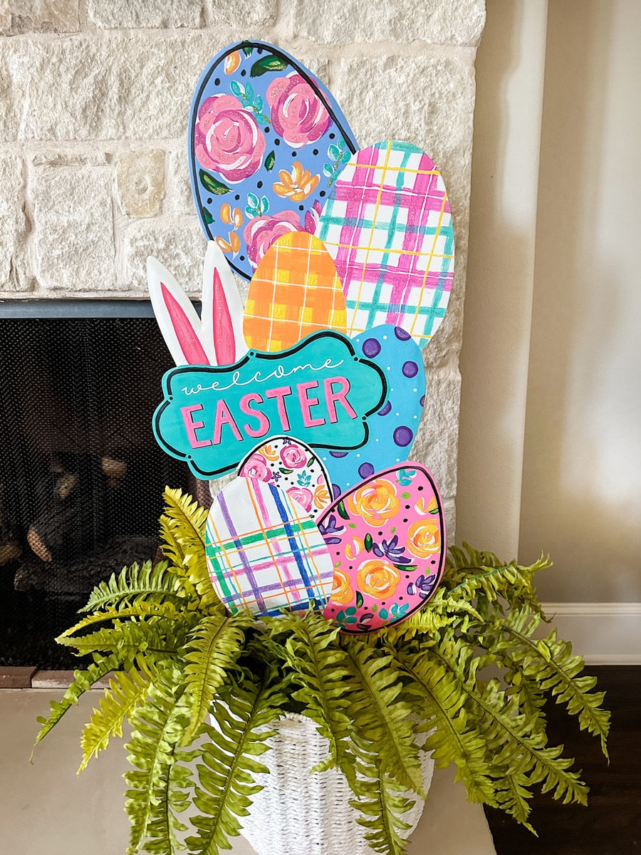 Artful Welcome Easter topiary with green foliage shaped into a tree silhouette.