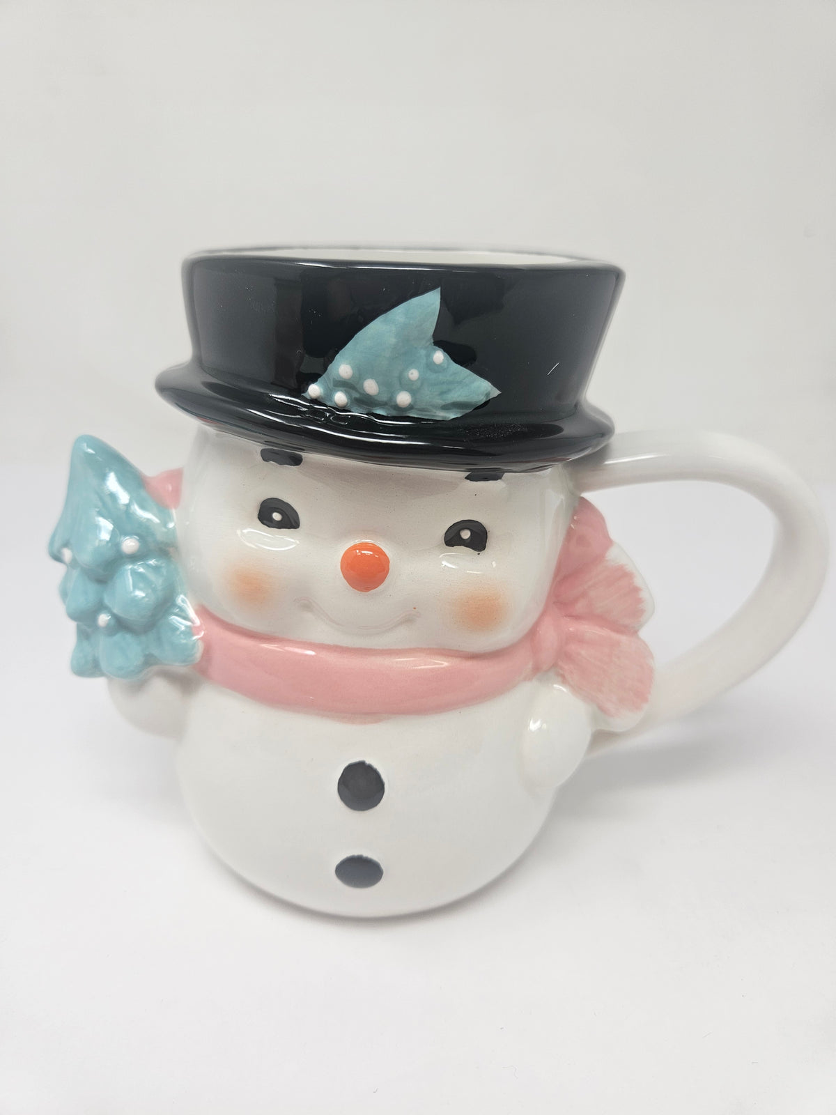 Pink vintage-style ceramic mug featuring a snowman illustration with black handle.