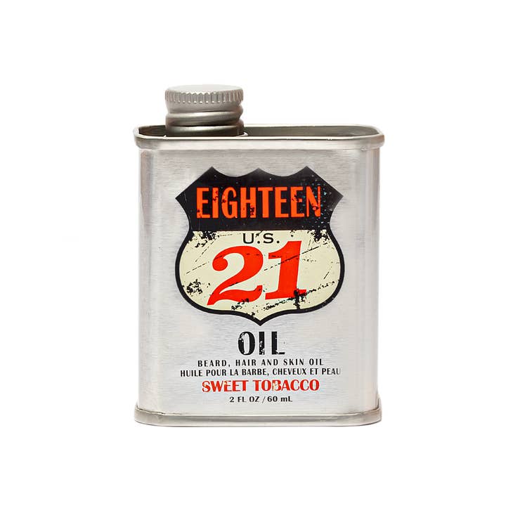 Bottle of Beard Hair and Skin Oil with amber liquid visible through clear glass