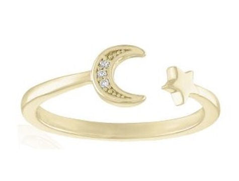 Open gold ring featuring a crescent moon set with cubic zirconia and a small star on the other end.