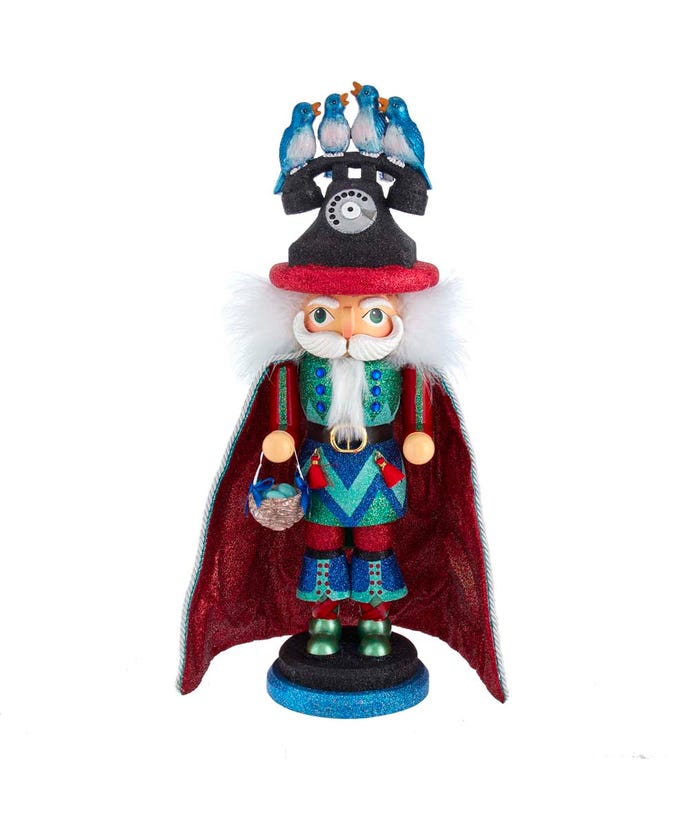 Wood composite nutcracker with glittered telephone hat holding a nest; four calling birds perched atop.