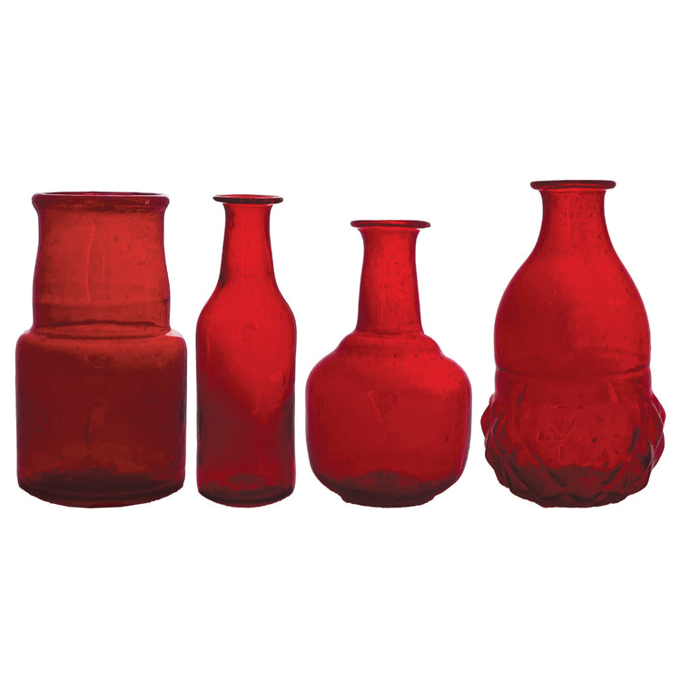 Four assorted hand-blown ruby red glass bud vases in various shapes and sizes.