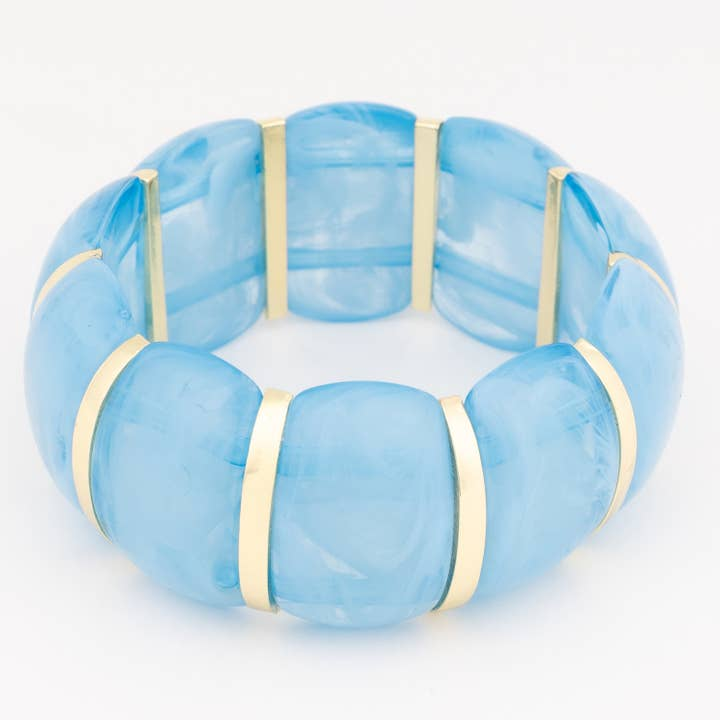 Talia Blue Bracelet featuring chunky marbled blue resin beads separated by gold-toned metal bars.