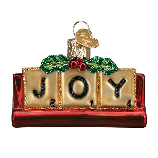 Joy ornament with a red glossy finish featuring white snowflake patterns.