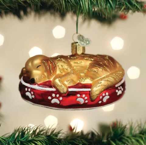 Golden Retriever dog ornament in gold metallic finish with sleepy expression.
