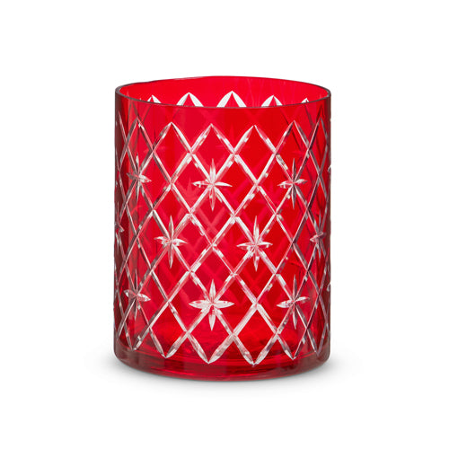 Red glass container with etched geometric patterns on a cylindrical shape.